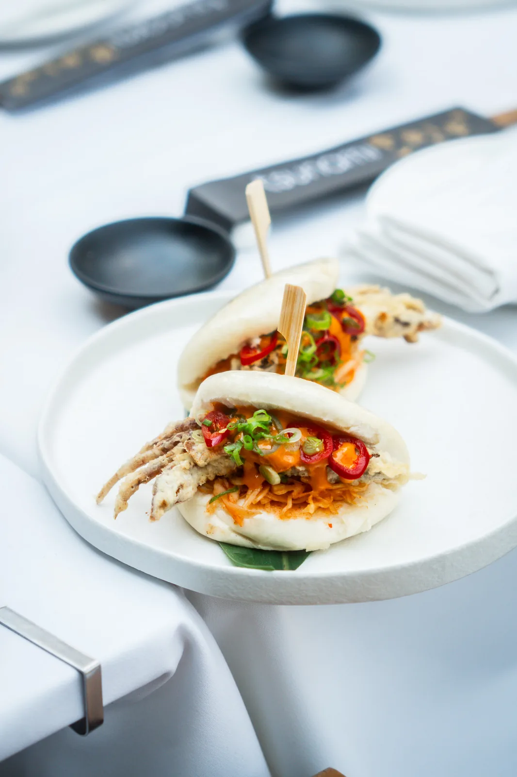 Soft-shell crab bao buns with kimchi slaw, sriracha mayo, red chilli and spring onion
