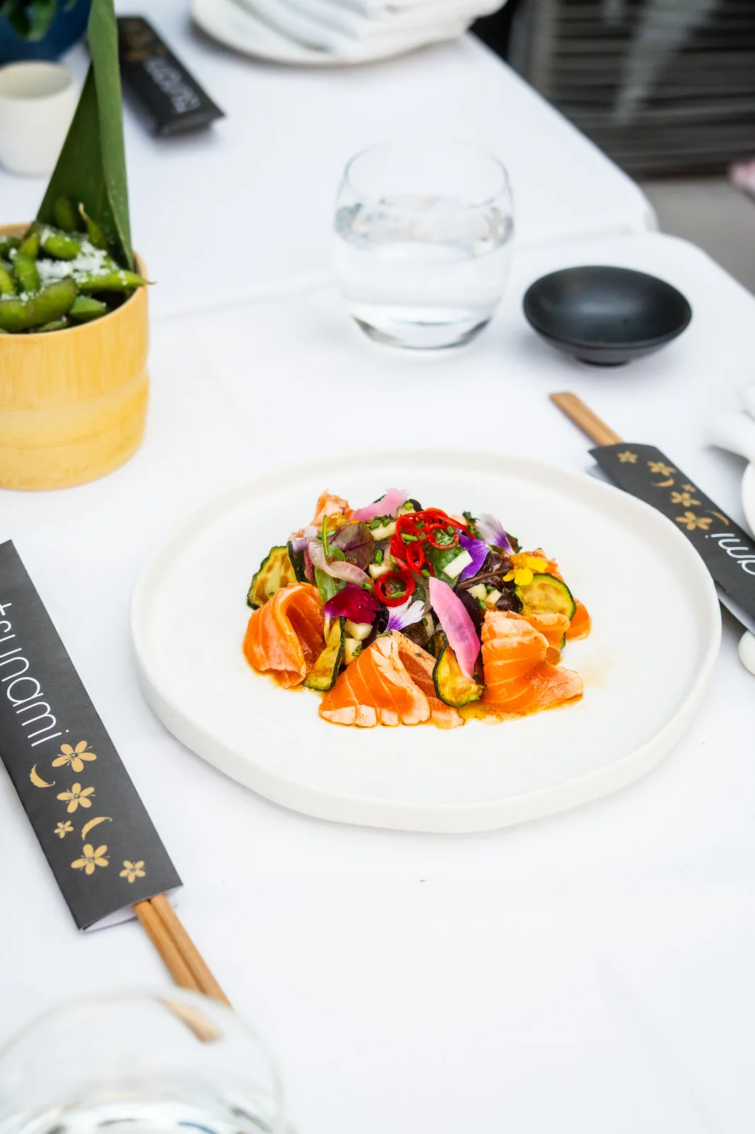 Salmon sashimi with edible flowers